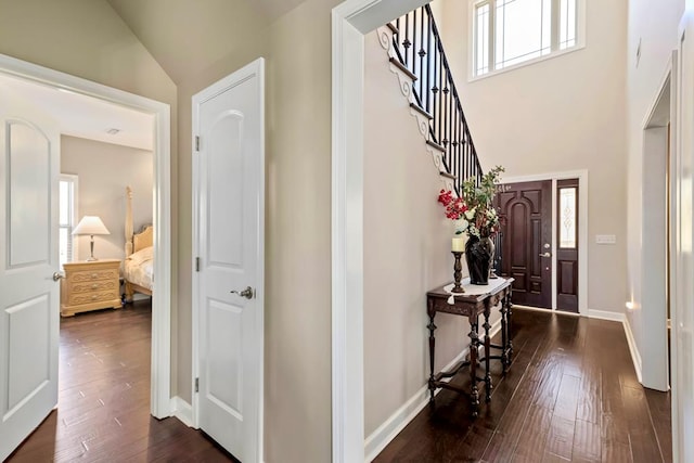 entrance foyer with high vaulted ceiling and dark wood-type flooring