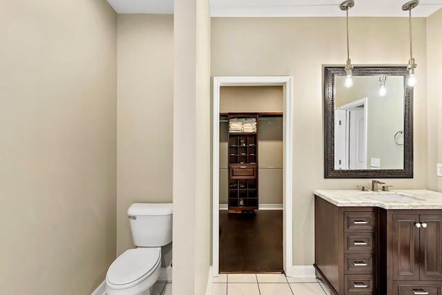 bathroom with tile patterned flooring, vanity, and toilet