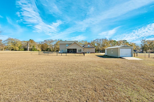 view of front of property with a garage, an outdoor structure, and a front lawn