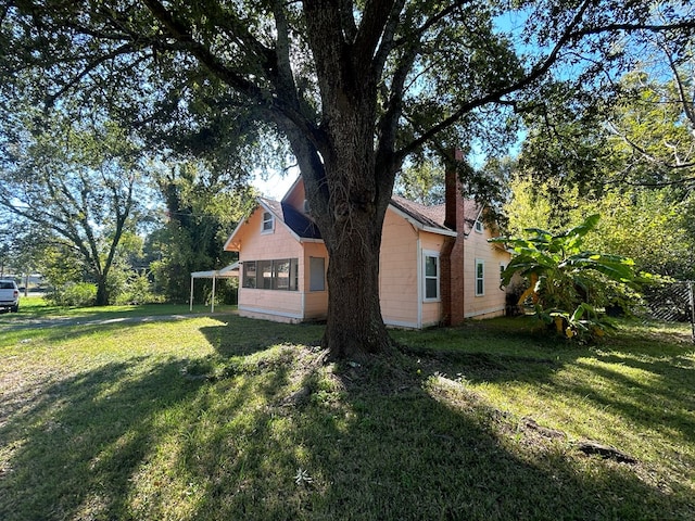 view of home's exterior with a lawn