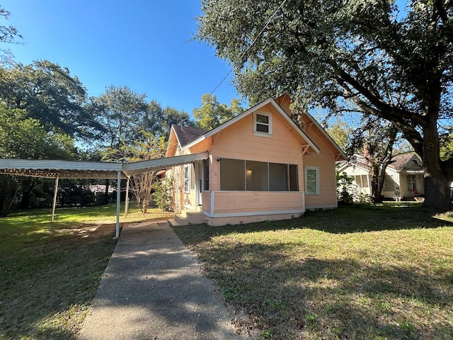 exterior space with a carport and a front yard