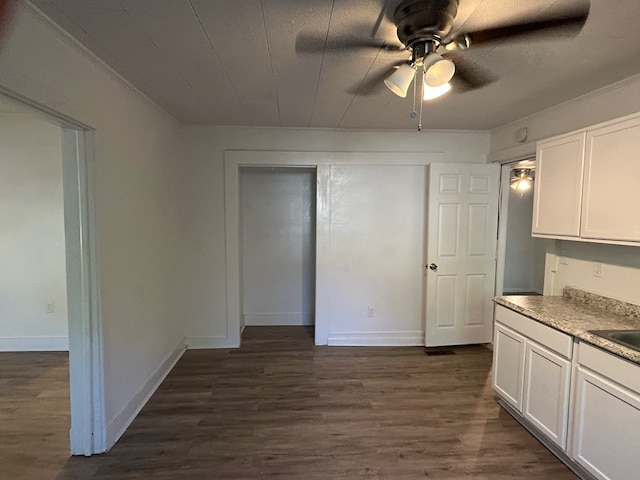 kitchen featuring ceiling fan, dark hardwood / wood-style flooring, and white cabinetry