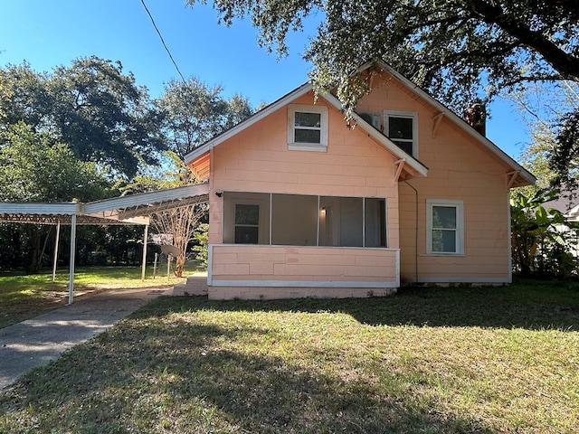 exterior space featuring a carport and a lawn