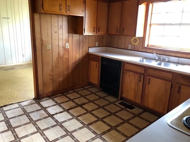5131 County Rd 417, Kinston, AL 36453 - kitchen featuring black dishwasher, light flooring, light countertops, brown cabinetry, and a sink