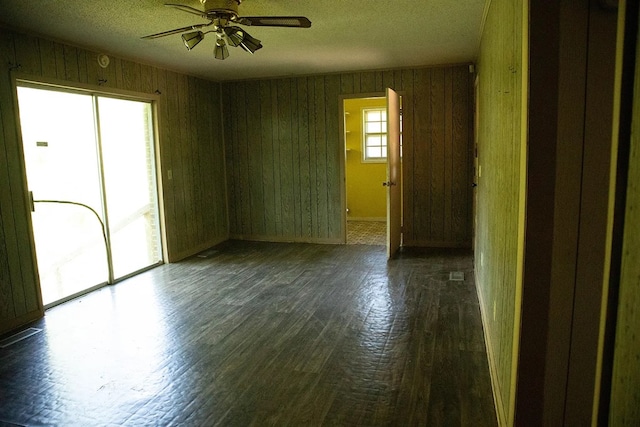 5131 County Rd 417, Kinston, AL 36453 - empty room featuring a ceiling fan, wood finished floors, a textured ceiling, and wood walls