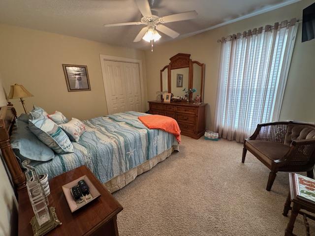 208 Craftsman Dr, Dothan, AL 36303 - bedroom with light carpet, a closet, and a ceiling fan