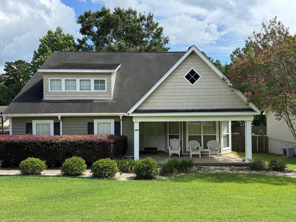 208 Craftsman Dr, Dothan, AL 36303 - view of front of home featuring covered porch, a front yard, and roof with shingles