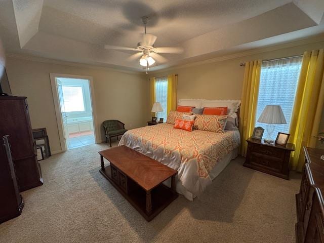 208 Craftsman Dr, Dothan, AL 36303 - bedroom featuring a tray ceiling, light colored carpet, ornamental molding, a ceiling fan, and connected bathroom