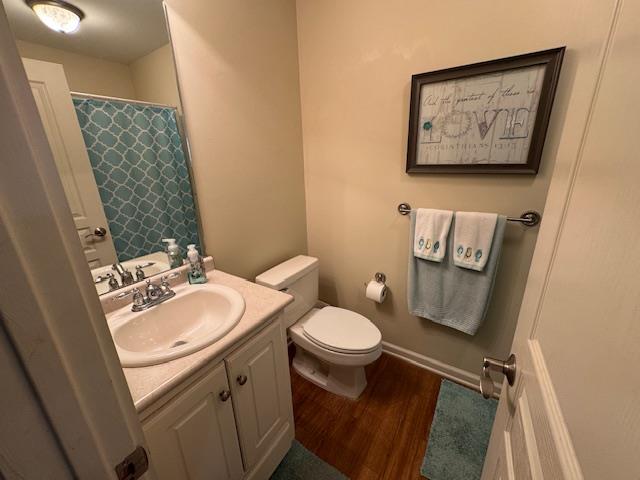 208 Craftsman Dr, Dothan, AL 36303 - bathroom with vanity, wood finished floors, and a shower with shower curtain