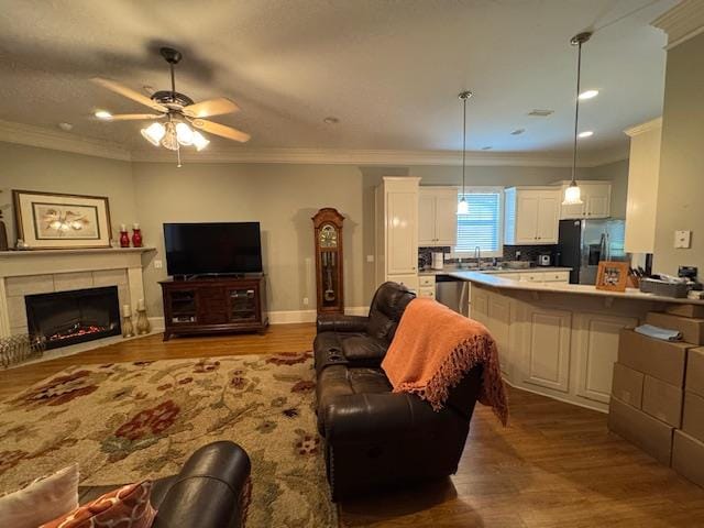 208 Craftsman Dr, Dothan, AL 36303 - living area featuring wood finished floors, ceiling fan, ornamental molding, a fireplace, and recessed lighting