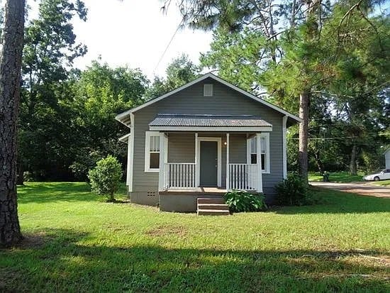 bungalow-style house featuring a front yard