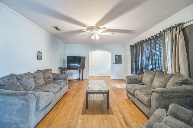 283 E King St, Newton, AL 36352 - living area with arched walkways, crown molding, ceiling fan, light wood-style floors, and baseboards