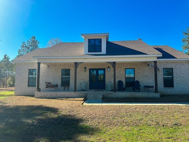 back of property with a porch