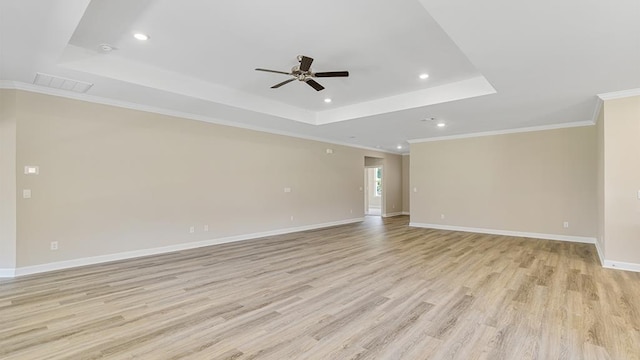 310 Heritage Way, Headland, AL 36345 - unfurnished room with a tray ceiling, visible vents, light wood-style flooring, and baseboards