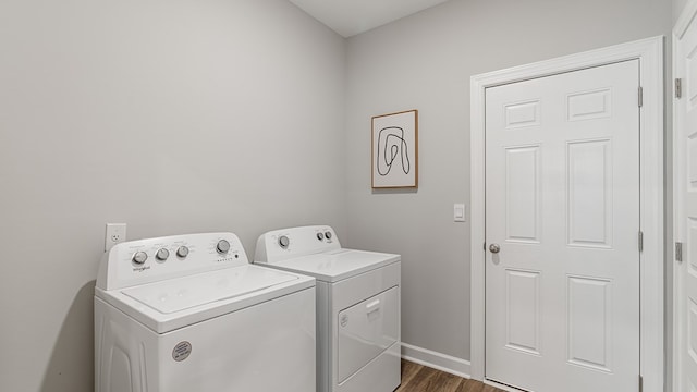 laundry room featuring dark wood-type flooring and independent washer and dryer