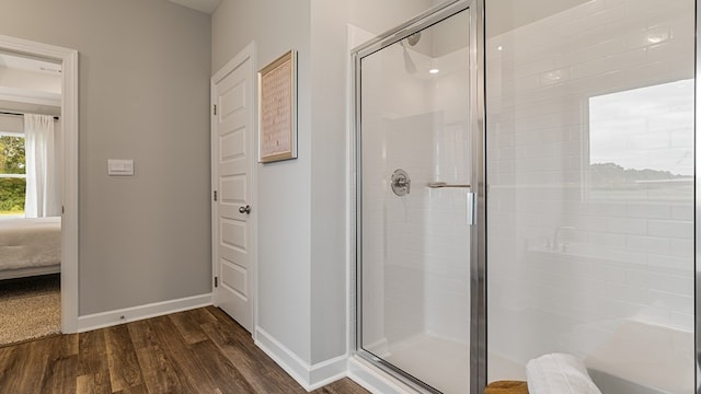 bathroom featuring an enclosed shower and hardwood / wood-style flooring