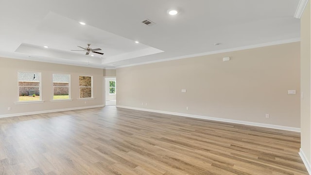 310 Heritage Way, Headland, AL 36345 - spare room featuring ceiling fan, recessed lighting, baseboards, light wood-type flooring, and a tray ceiling