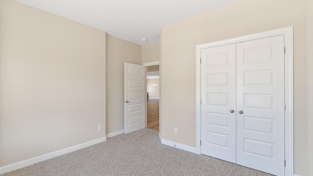 310 Heritage Way, Headland, AL 36345 - unfurnished bedroom with carpet, a closet, and baseboards