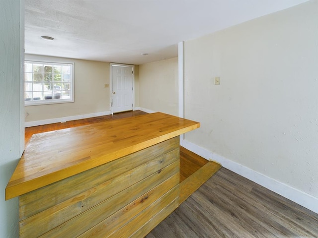 empty room featuring baseboards and wood finished floors