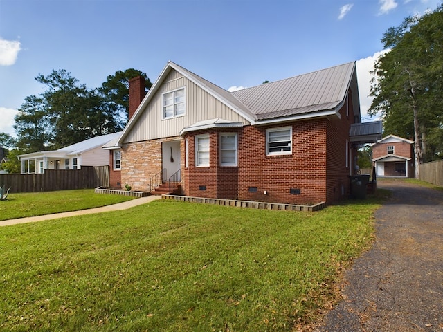 bungalow-style home with aphalt driveway, entry steps, a chimney, crawl space, and fence
