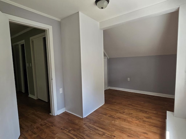 bonus room with dark wood-type flooring and baseboards