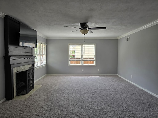 unfurnished living room featuring a tile fireplace, light colored carpet, visible vents, a ceiling fan, and crown molding