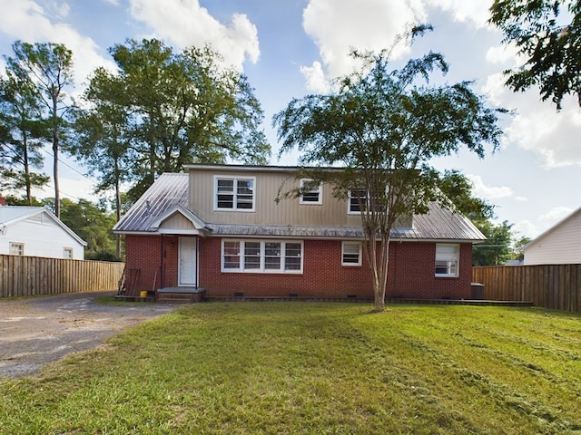 view of front of house with driveway, fence, a front yard, and brick siding