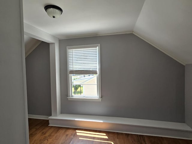 bonus room with vaulted ceiling, wood finished floors, and baseboards
