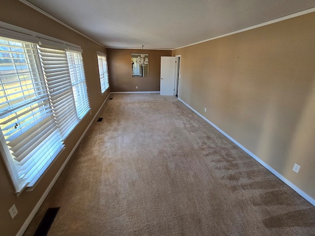 empty room with carpet flooring, a healthy amount of sunlight, and crown molding