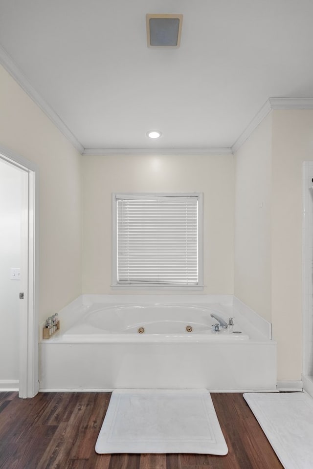 bathroom featuring a bathtub, hardwood / wood-style floors, and crown molding