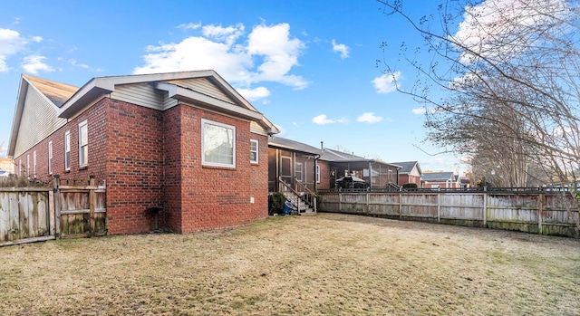 view of side of home with a lawn and a sunroom