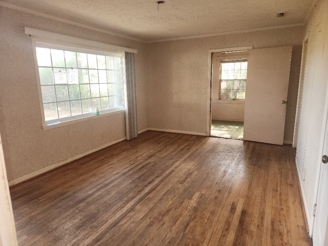 unfurnished room featuring hardwood / wood-style flooring and crown molding