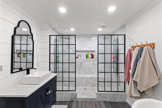 bathroom with tile patterned flooring, vanity, a tile shower, and crown molding