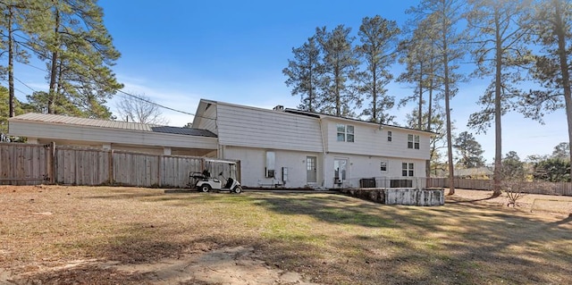 back of house featuring a yard and cooling unit