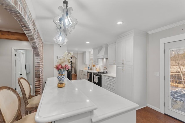 kitchen featuring stainless steel dishwasher, custom exhaust hood, black range with gas cooktop, white cabinets, and hanging light fixtures