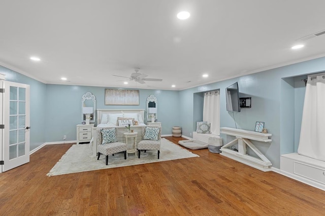 bedroom with hardwood / wood-style floors, ceiling fan, and crown molding