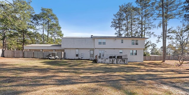 rear view of house with a yard