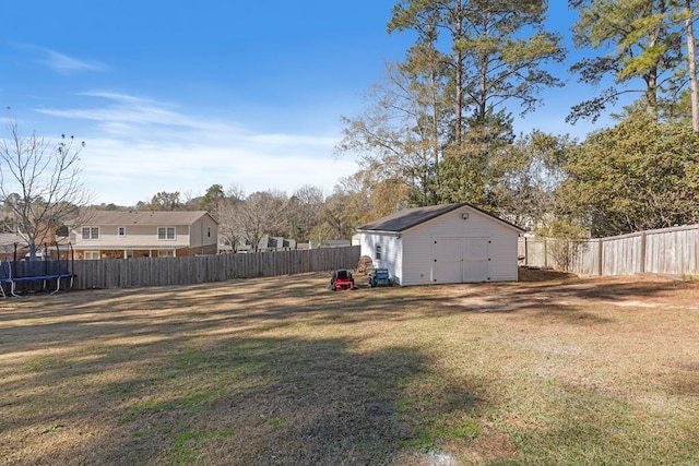 view of yard with a storage shed and a trampoline