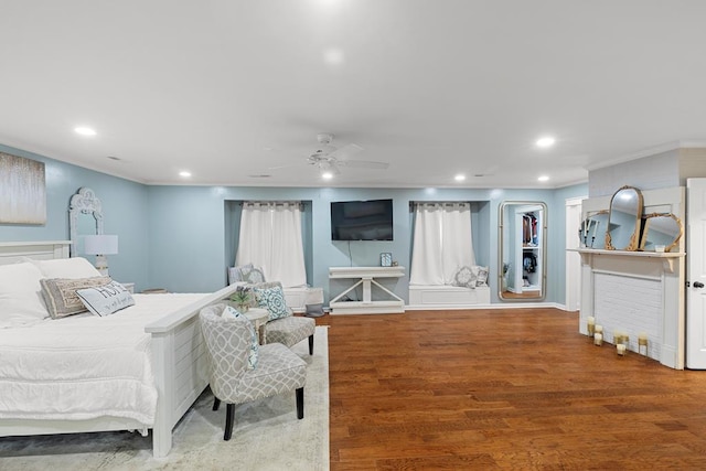 bedroom featuring hardwood / wood-style flooring, ceiling fan, and ornamental molding