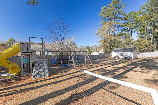 view of jungle gym featuring a trampoline and a storage unit