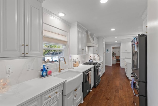 kitchen with white cabinets, sink, decorative backsplash, dark hardwood / wood-style floors, and appliances with stainless steel finishes