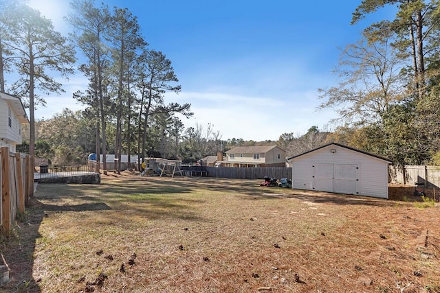 view of yard with a playground and a storage shed