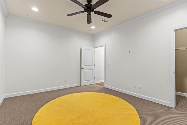 carpeted bedroom featuring baseboards, crown molding, visible vents, and a closet