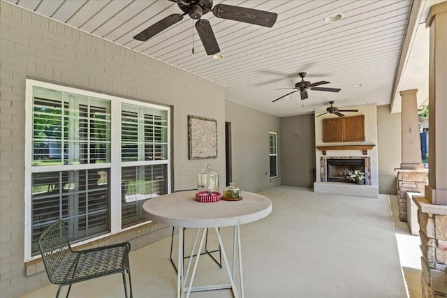 exterior space with a ceiling fan and exterior fireplace