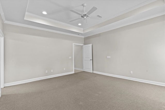 carpeted empty room featuring recessed lighting, a raised ceiling, ceiling fan, and crown molding