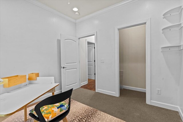 carpeted office with crown molding and baseboards