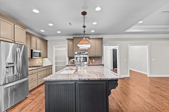 kitchen featuring recessed lighting, appliances with stainless steel finishes, ornamental molding, and a sink