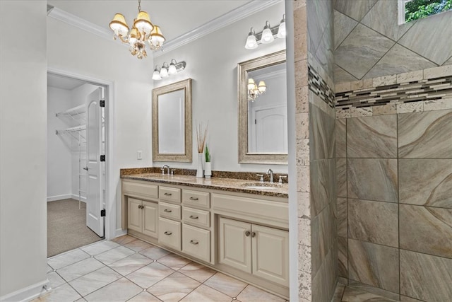 full bath with a sink, a notable chandelier, and ornamental molding