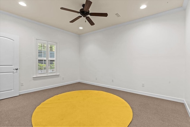 spare room with baseboards, crown molding, dark colored carpet, and visible vents