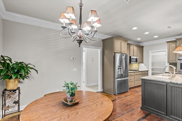 kitchen with ornamental molding, a chandelier, stainless steel appliances, and a sink